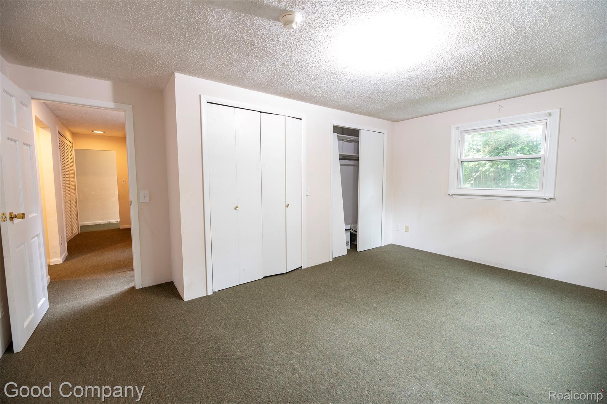 3685 Cone Avenue Rochester, MI 48309 - Photo 14 of 23 Carpeted room featuring a white window frame, white walls, and multiple built-in closets