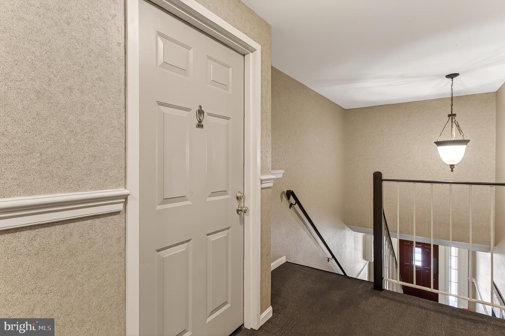 5833 Cove Landing Road, Unit 304 Burke, VA 22015 - Photo 28 of 34 a view of a hallway with entryway and stairs