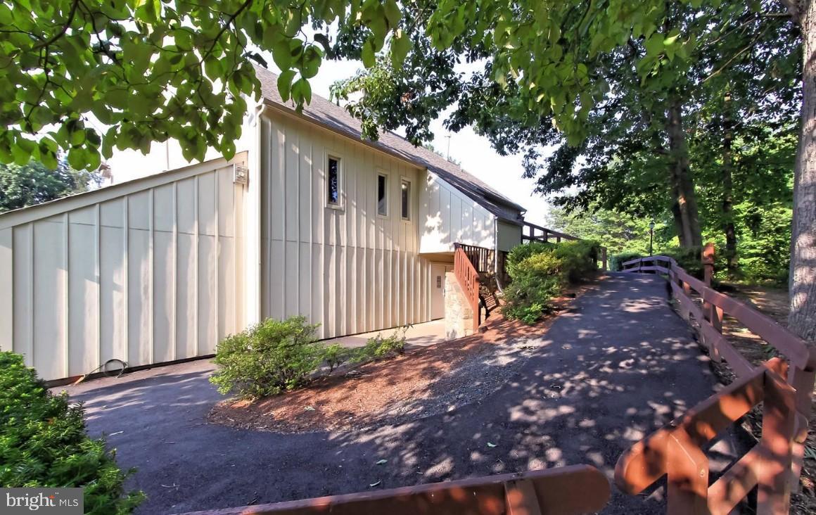5833 Cove Landing Road, Unit 304 Burke, VA 22015 - Photo 29 of 34 a front view of a house with garden