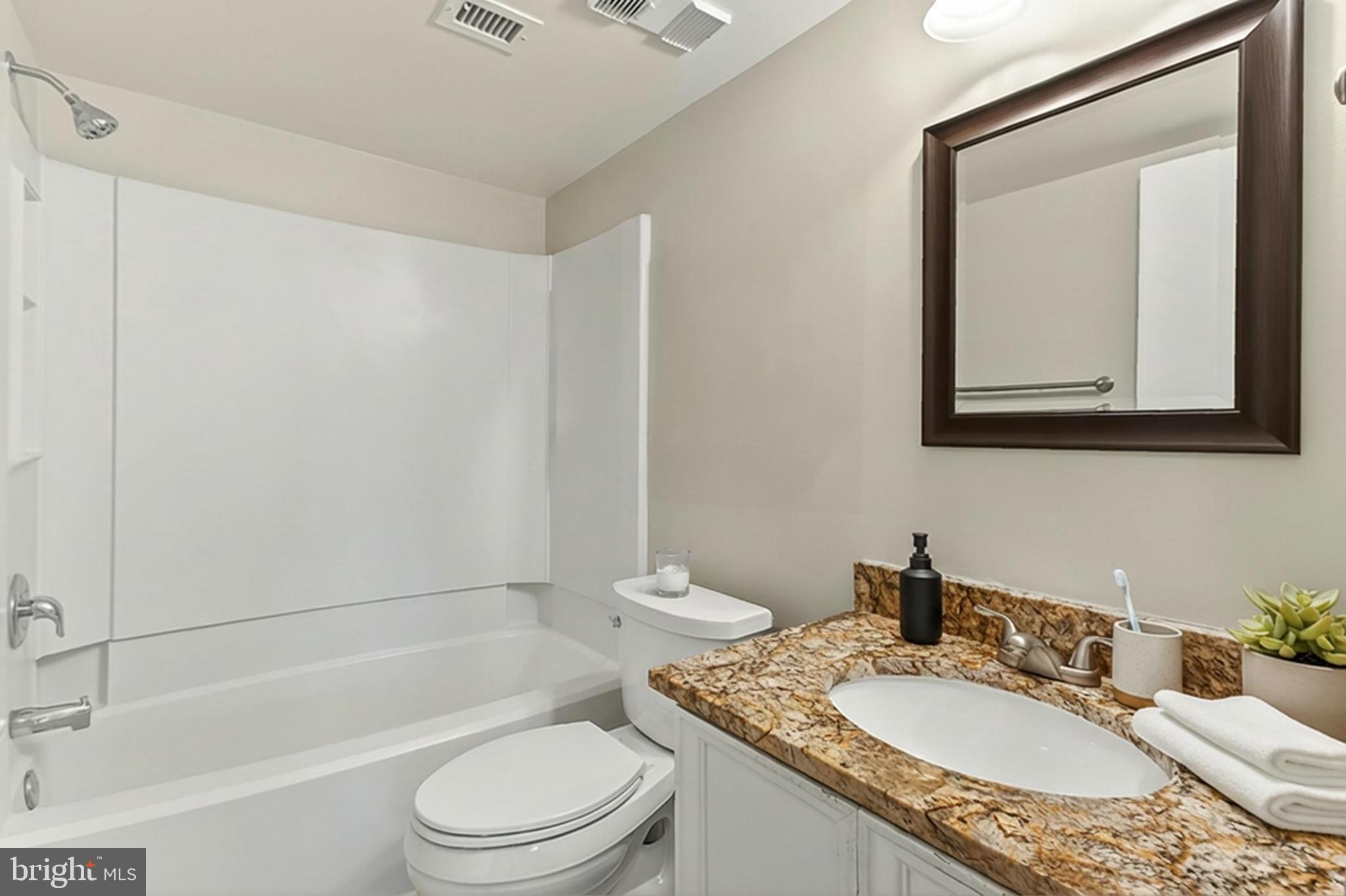 5833 Cove Landing Road, Unit 304 Burke, VA 22015 - Photo 7 of 34 a bathroom with a granite countertop sink toilet and shower