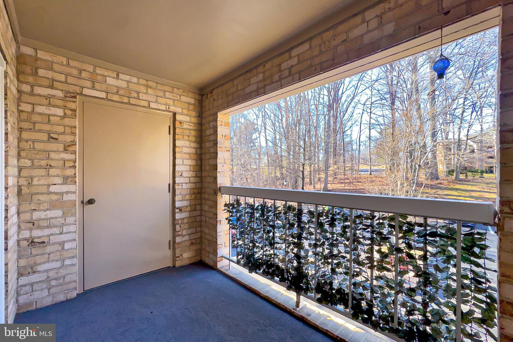 5833 Cove Landing Road, Unit 304 Burke, VA 22015 - Photo 8 of 34 a view of a porch with wooden floor