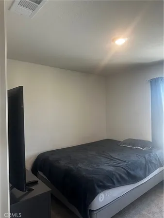 a bedroom with a bed and a table