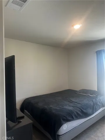 a bedroom with a bed and a table