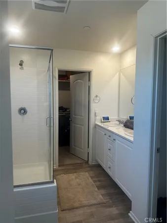 a bathroom with a shower sink and mirror