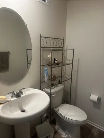 a bathroom with a sink toilet and mirror