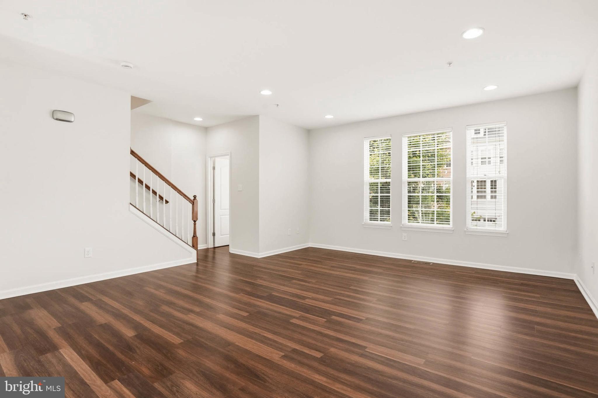 9817 Solar Course Laurel, MD 20723 - Photo 11 of 59 wooden floor in an empty room with a window