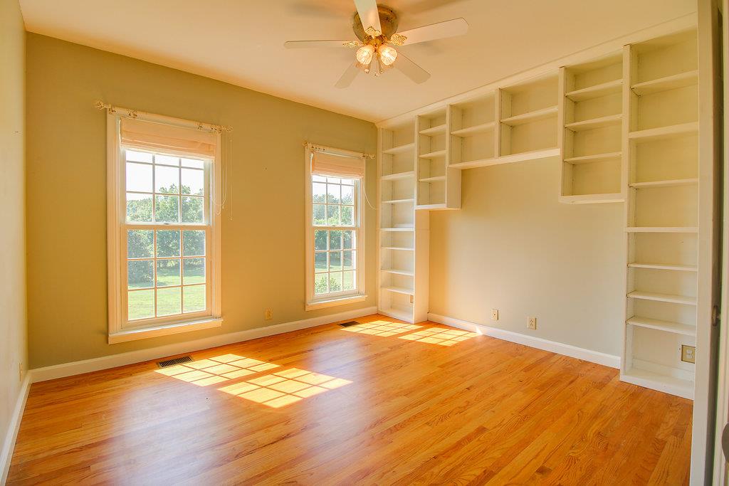 2727 Henry Gower Road Pleasant View, TN 37146 - Photo 11 of 30 a view of an empty room with wooden floor and a window