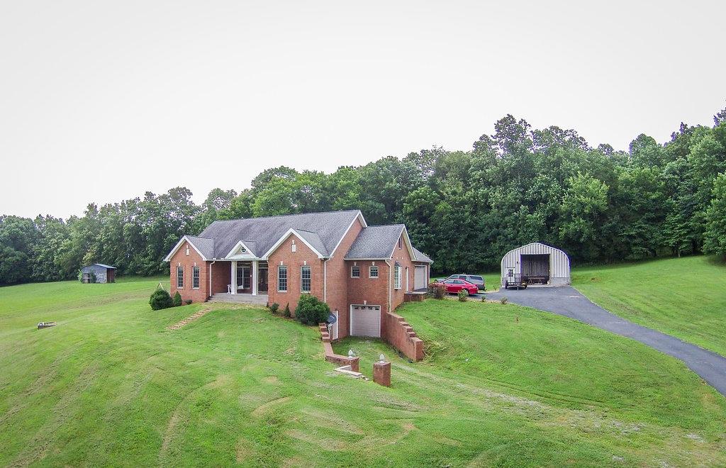 2727 Henry Gower Road Pleasant View, TN 37146 - Photo 19 of 30 an aerial view of a house with a garden and large trees