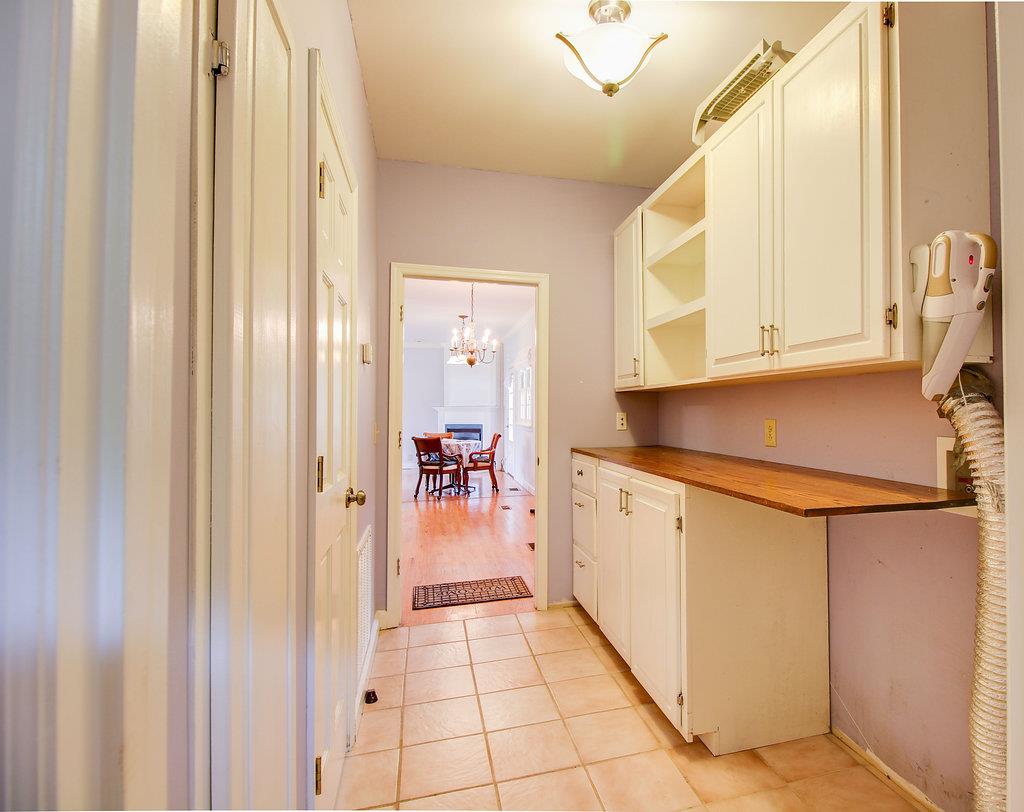2727 Henry Gower Road Pleasant View, TN 37146 - Photo 25 of 30 a kitchen with a refrigerator and white cabinets