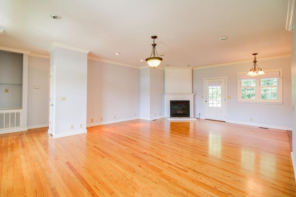 2727 Henry Gower Road Pleasant View, TN 37146 - Photo 27 of 30 a view of empty room with wooden floor and fireplace