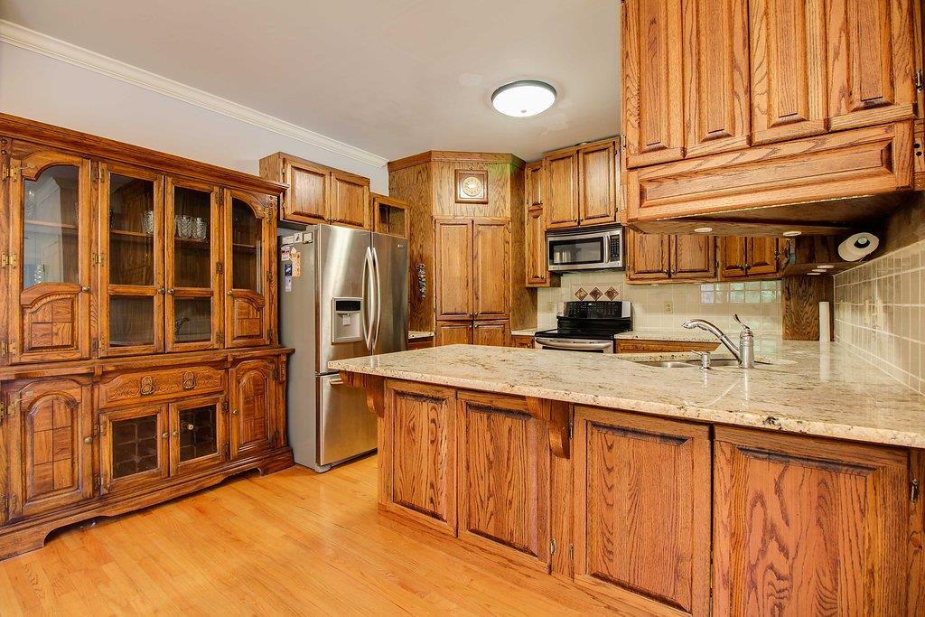 2727 Henry Gower Road Pleasant View, TN 37146 - Photo 6 of 30 a kitchen with stainless steel appliances granite countertop a refrigerator a stove and a sink with cabinets