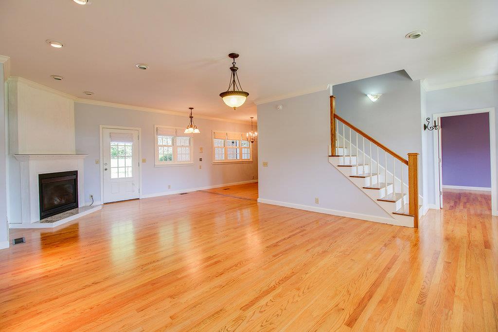 2727 Henry Gower Road Pleasant View, TN 37146 - Photo 8 of 30 a view of an empty room with wooden floor fireplace and a window