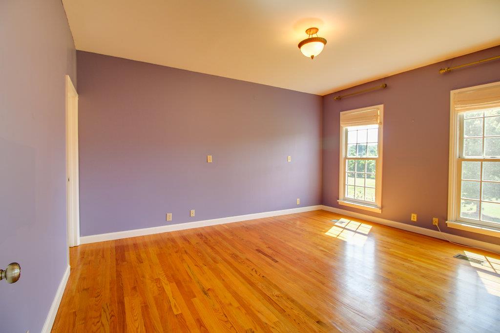 2727 Henry Gower Road Pleasant View, TN 37146 - Photo 10 of 30 a view of empty room with wooden floor and fan