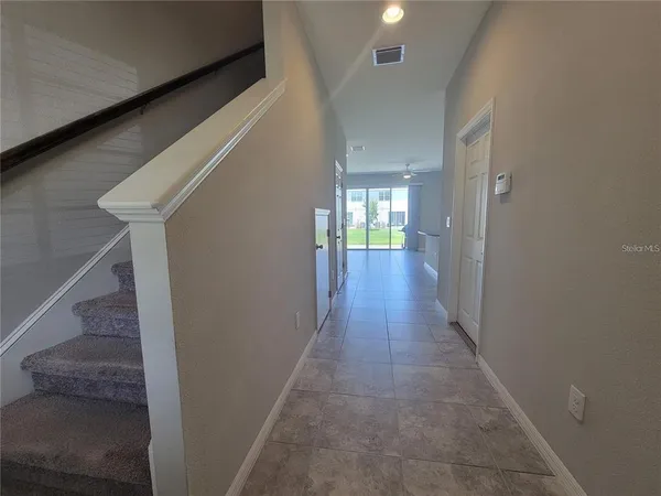 a view of hallway with wooden floor