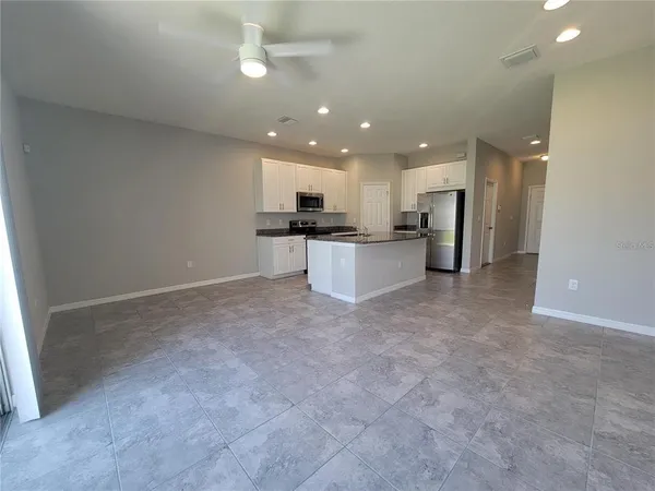 a view of a kitchen with a sink and a refrigerator