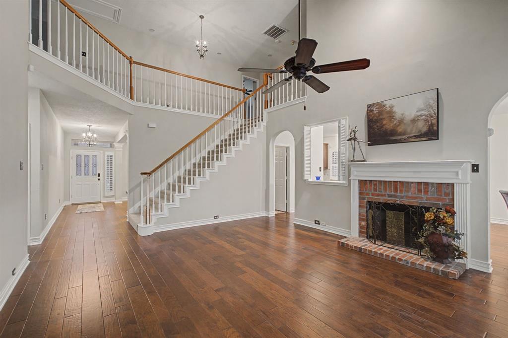 2705 Wind Ridge McKinney, TX 75072 - Photo 13 of 40 a view of empty room with wooden floor fireplace and a window