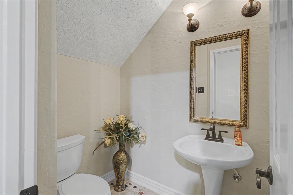 2705 Wind Ridge McKinney, TX 75072 - Photo 16 of 40 a bathroom with a toilet a sink and mirror