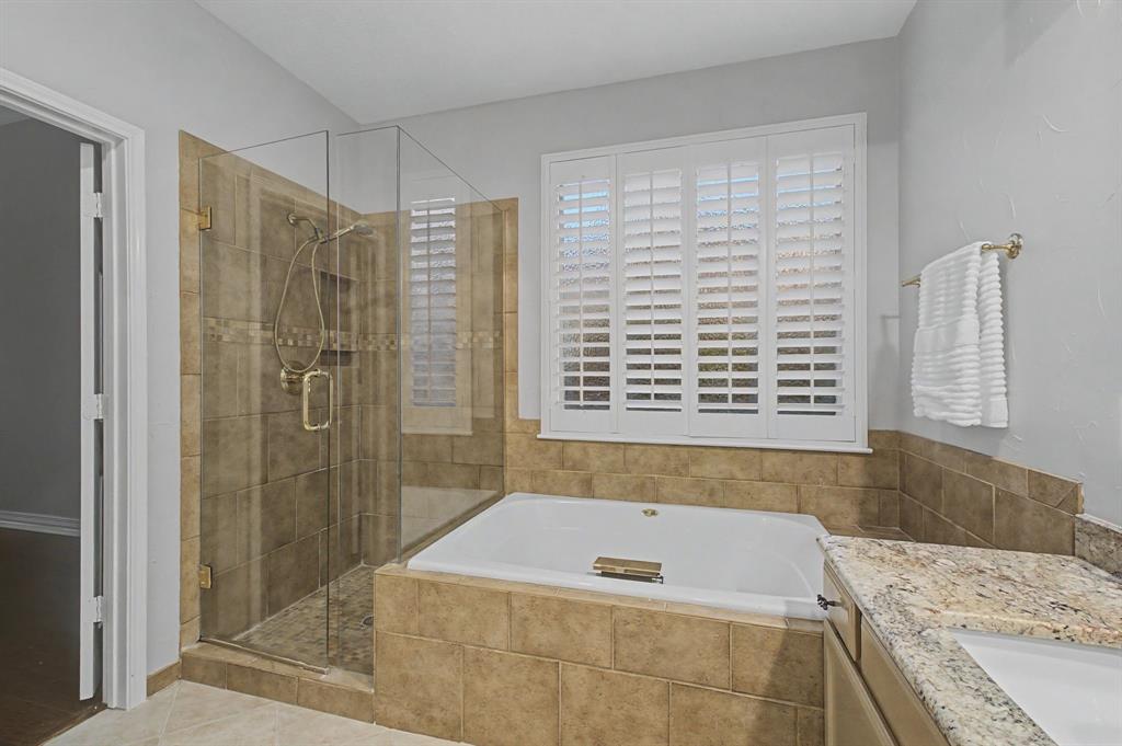2705 Wind Ridge McKinney, TX 75072 - Photo 27 of 40 a bathroom with a tub shower and sink