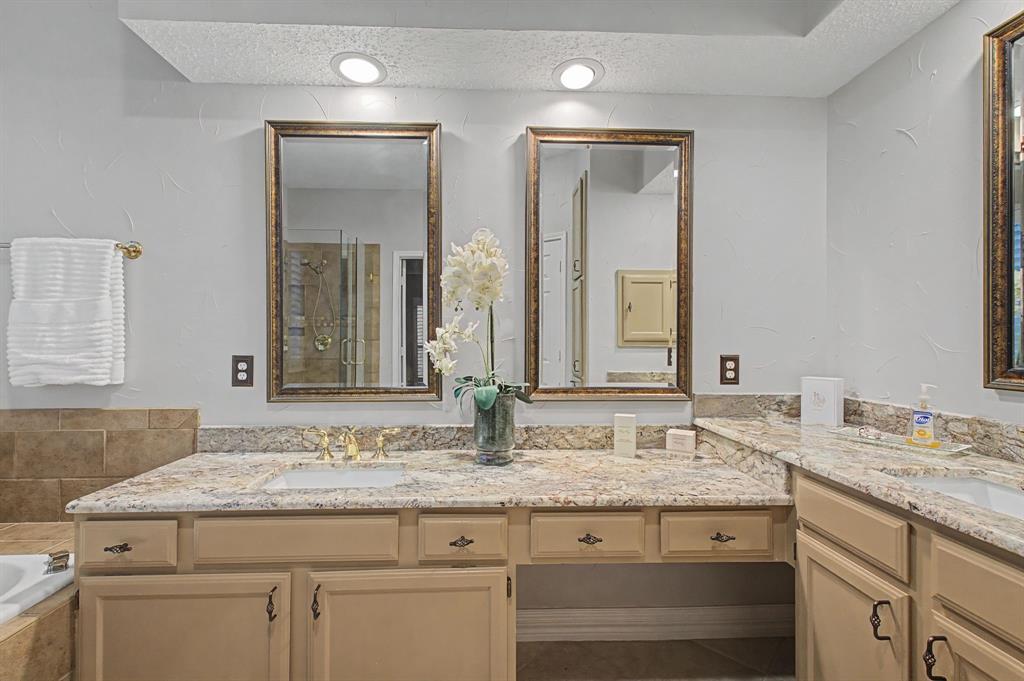 2705 Wind Ridge McKinney, TX 75072 - Photo 28 of 40 a bathroom with a granite countertop sink and a mirror