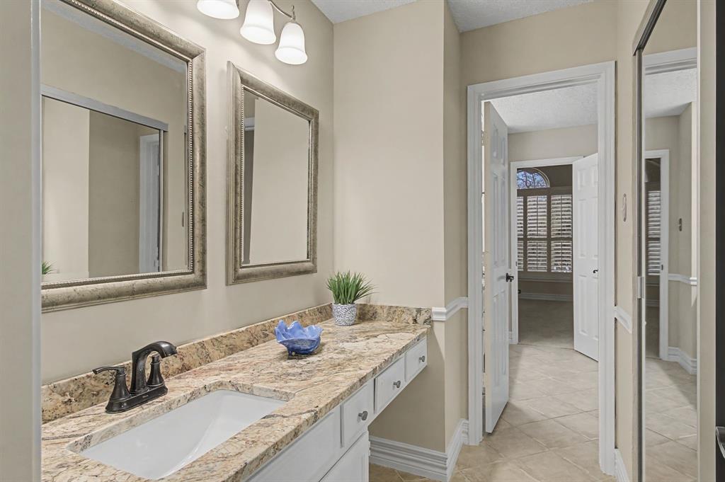 2705 Wind Ridge McKinney, TX 75072 - Photo 33 of 40 a bathroom with a sink vanity and mirror