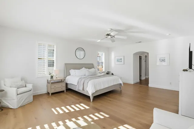 a spacious bedroom with a bed and a couch