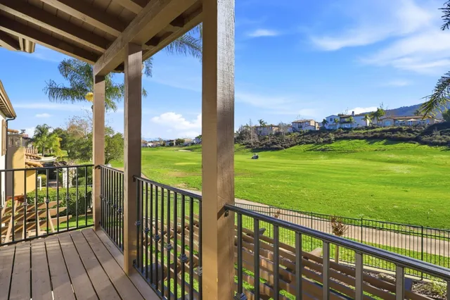 a view of a balcony with floor to ceiling windows with wooden floor