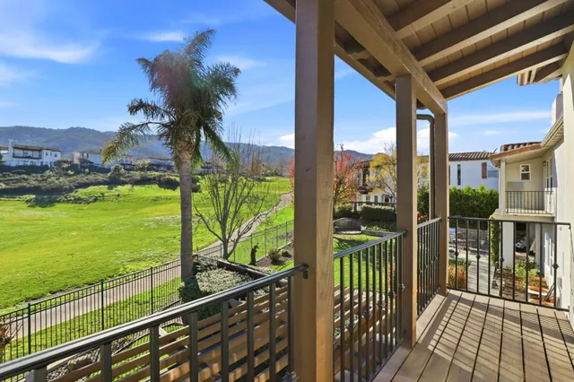 a view of a patio with a table chairs and a backyard