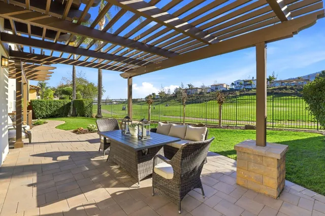 a view of a house with backyard porch and sitting area