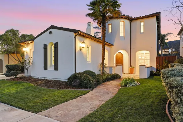 a front view of a house with garden