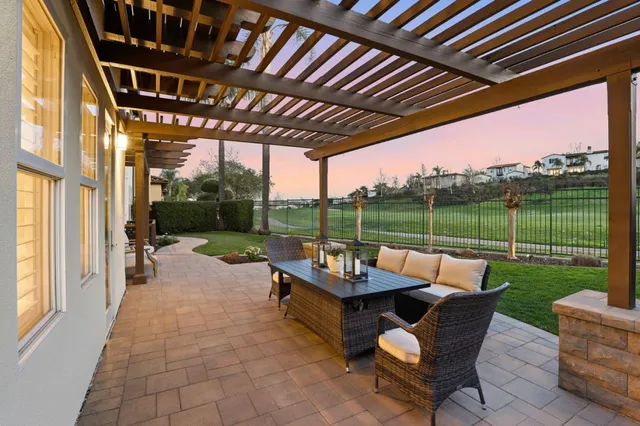 a view of a backyard with furniture and a garden