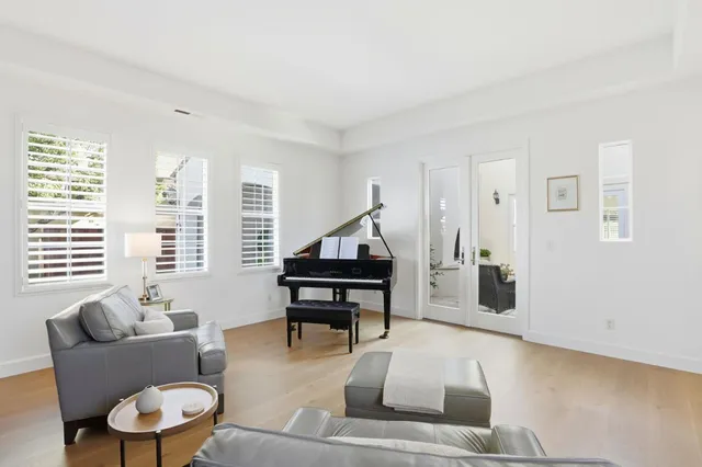 a living room with furniture and a piano