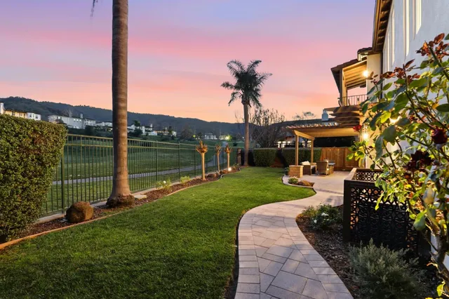 a view of a chair and table in the backyard