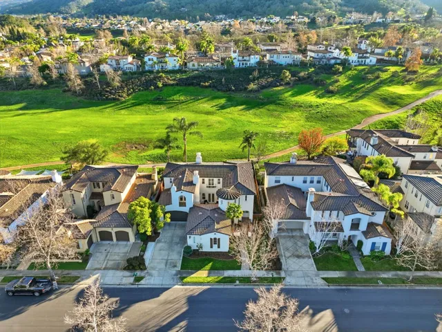 an aerial view of a house with garden space and ocean view