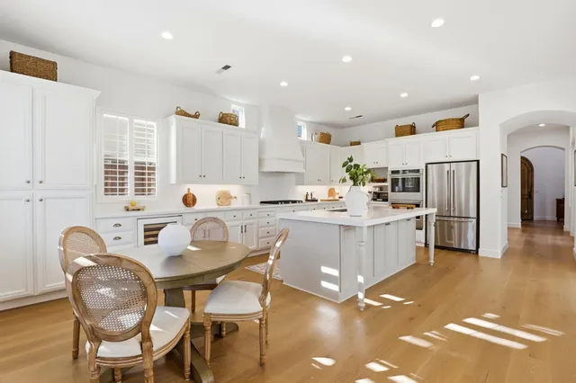 a kitchen with white cabinets and stainless steel appliances