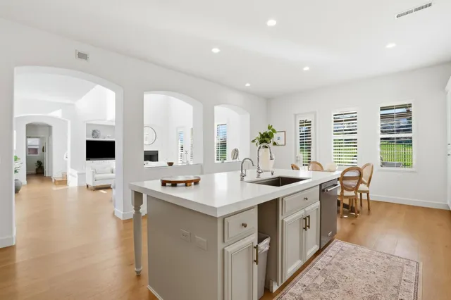 a large white kitchen with a large window