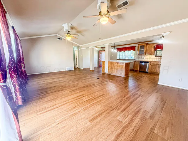 a view of a livingroom with hardwood floor and a ceiling fan