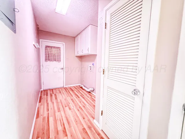 a view of a bedroom with wooden floor and closet