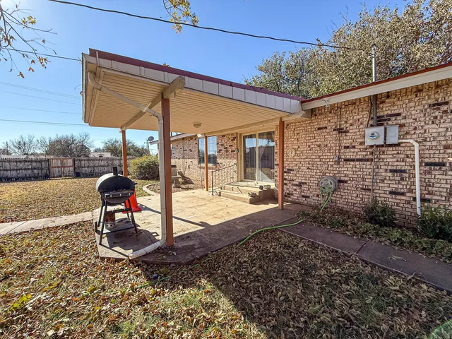 a backyard of a house with outdoor seating