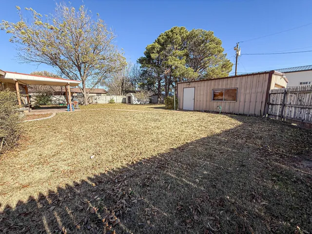a view of yard covered with snow in front of house