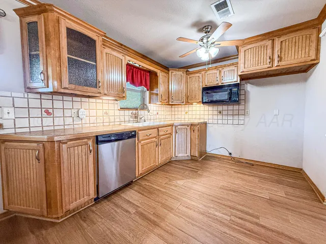 a kitchen with stainless steel appliances granite countertop a sink and cabinets
