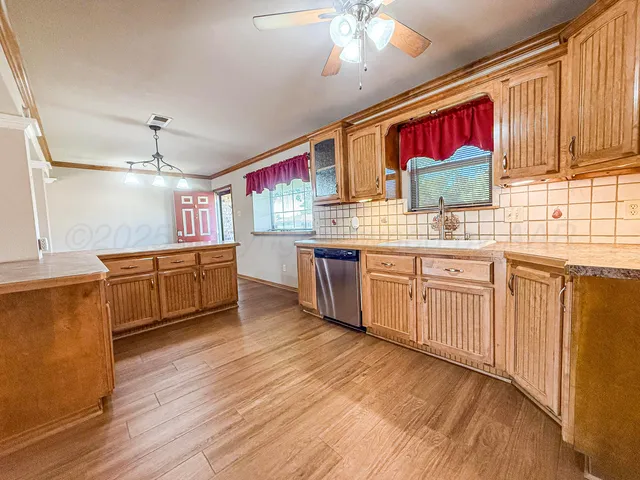 a kitchen with stainless steel appliances kitchen island wooden cabinets and granite counter tops