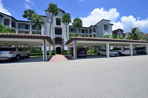 a view of a building with car parked