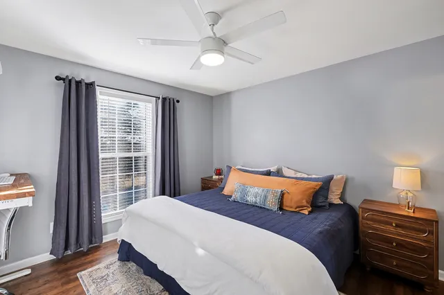a bedroom with a large bed and a chandelier