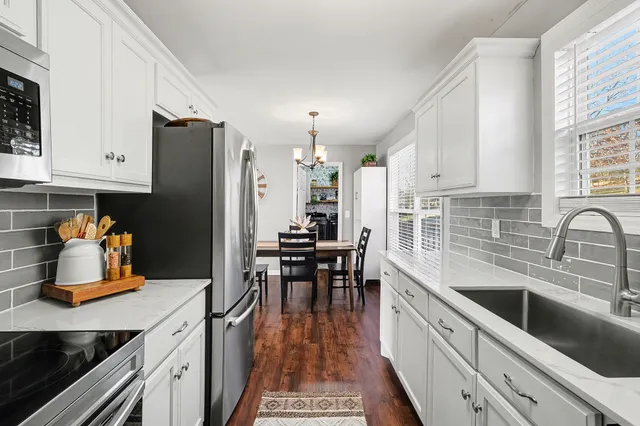 a kitchen with a sink a counter top space and stainless steel appliances