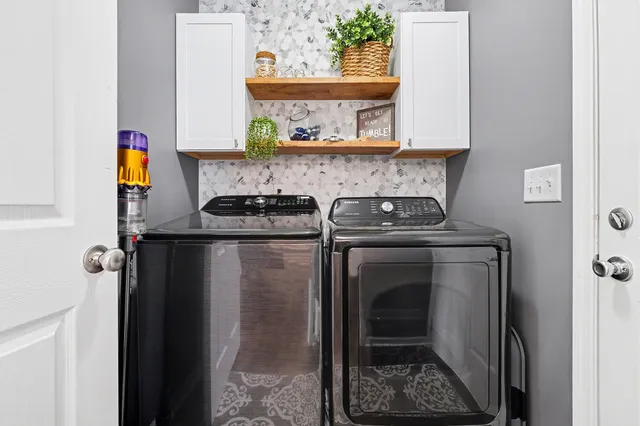 a close view of a utility room with dryer and washer
