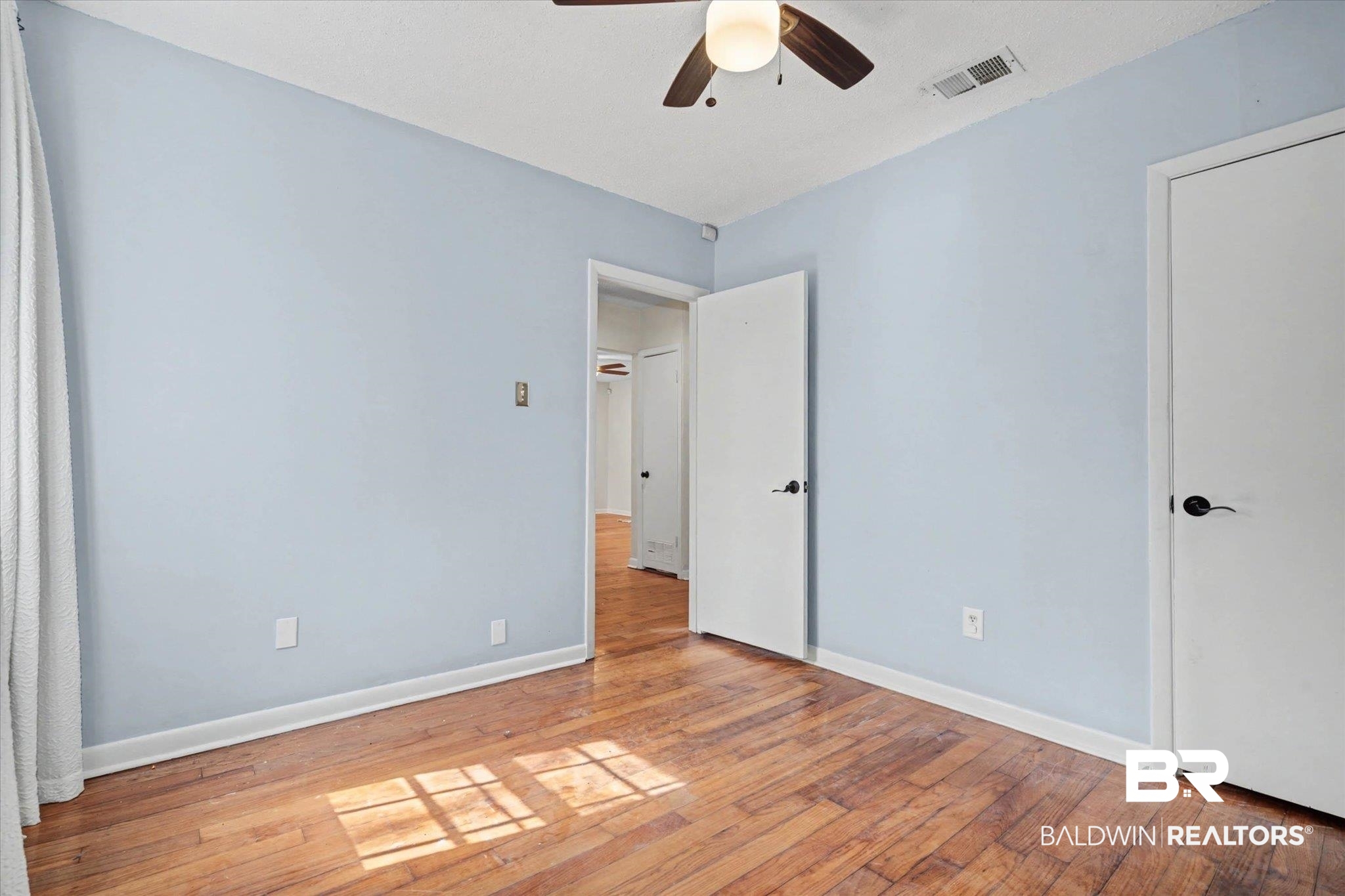 5117 Norton Lane Mobile, AL 36608 - Photo 19 of 35 Unfurnished bedroom with light wood-type flooring and a ceiling fan