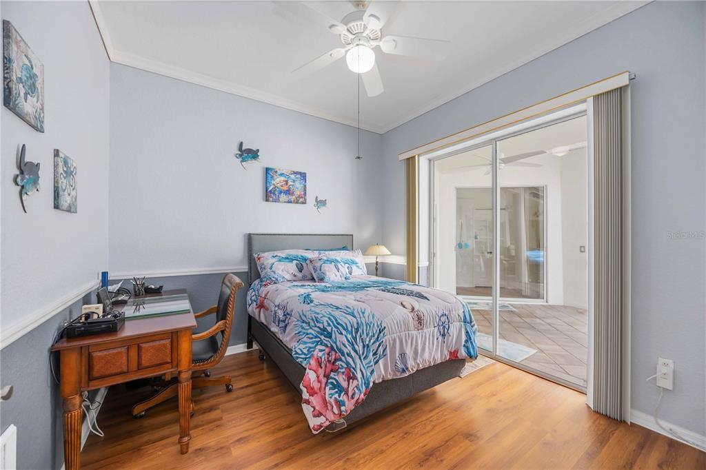 48 Bunker Road Rotonda West, FL 33947 - Photo 31 of 59 a bedroom with a bed and a chandelier