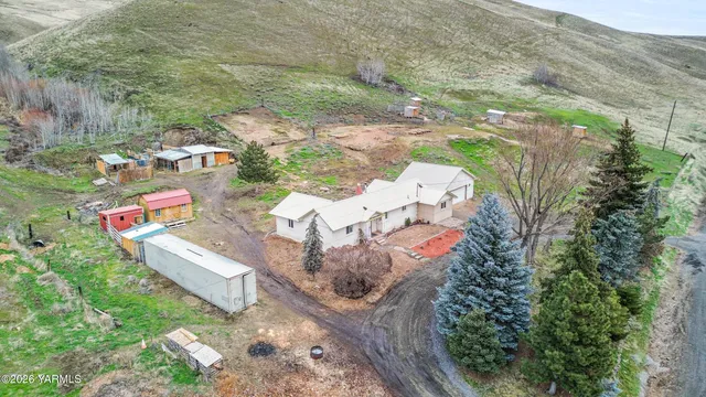 an aerial view of a house with a yard