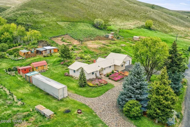 an aerial view of residential house with an outdoor space and seating
