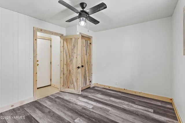 a view of a livingroom with wooden floor and a window